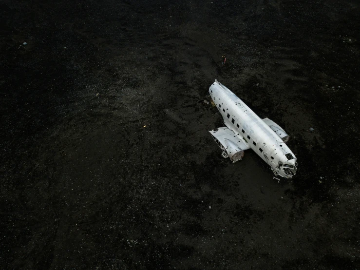 a space shuttle parked on the ground in a dark area