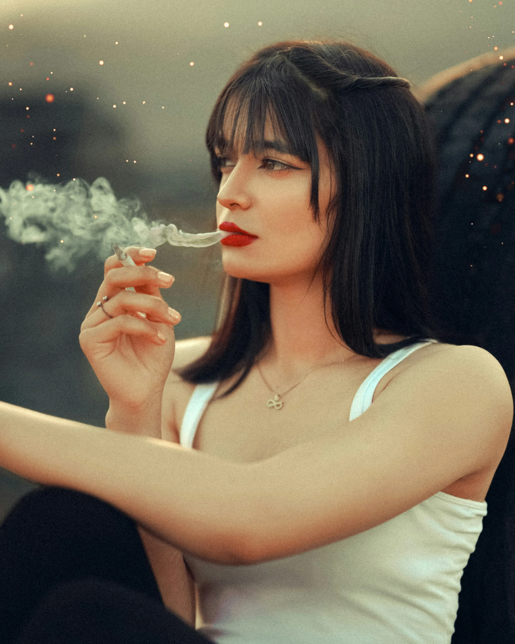 a woman sitting on a couch smoking a cigarette