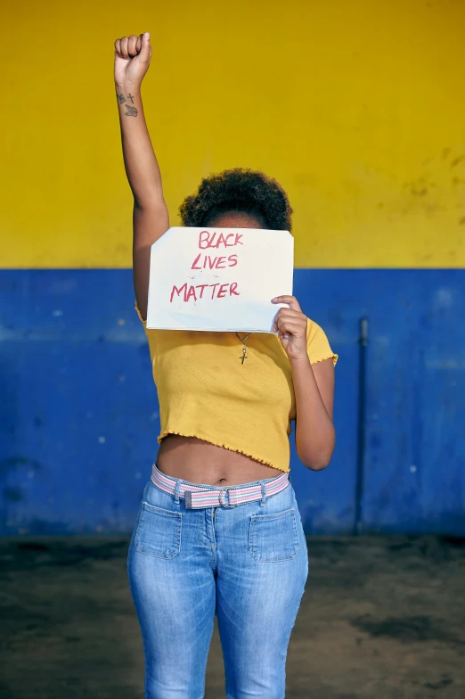 a woman is holding a sign in the air