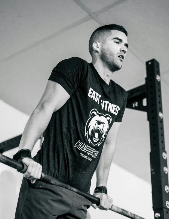 a black and white image of a man doing the incline with a bar