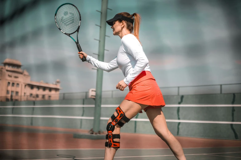 a woman playing tennis wearing a white shirt