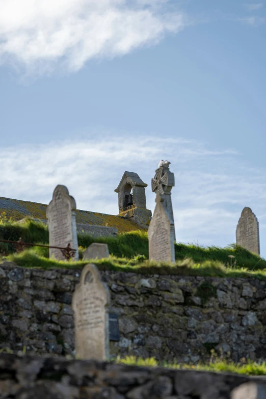 a cemetery of tombstones with the sky in the background