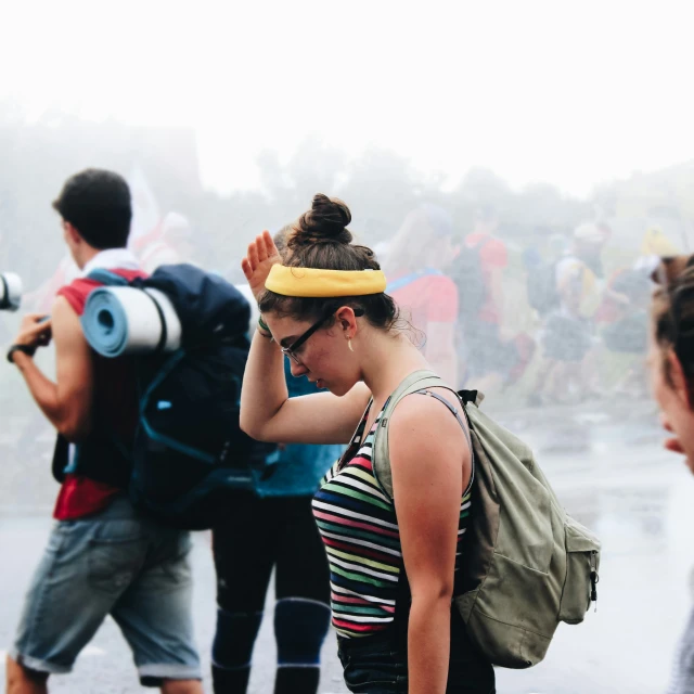 the girl with the yellow band is taking pictures of the crowd