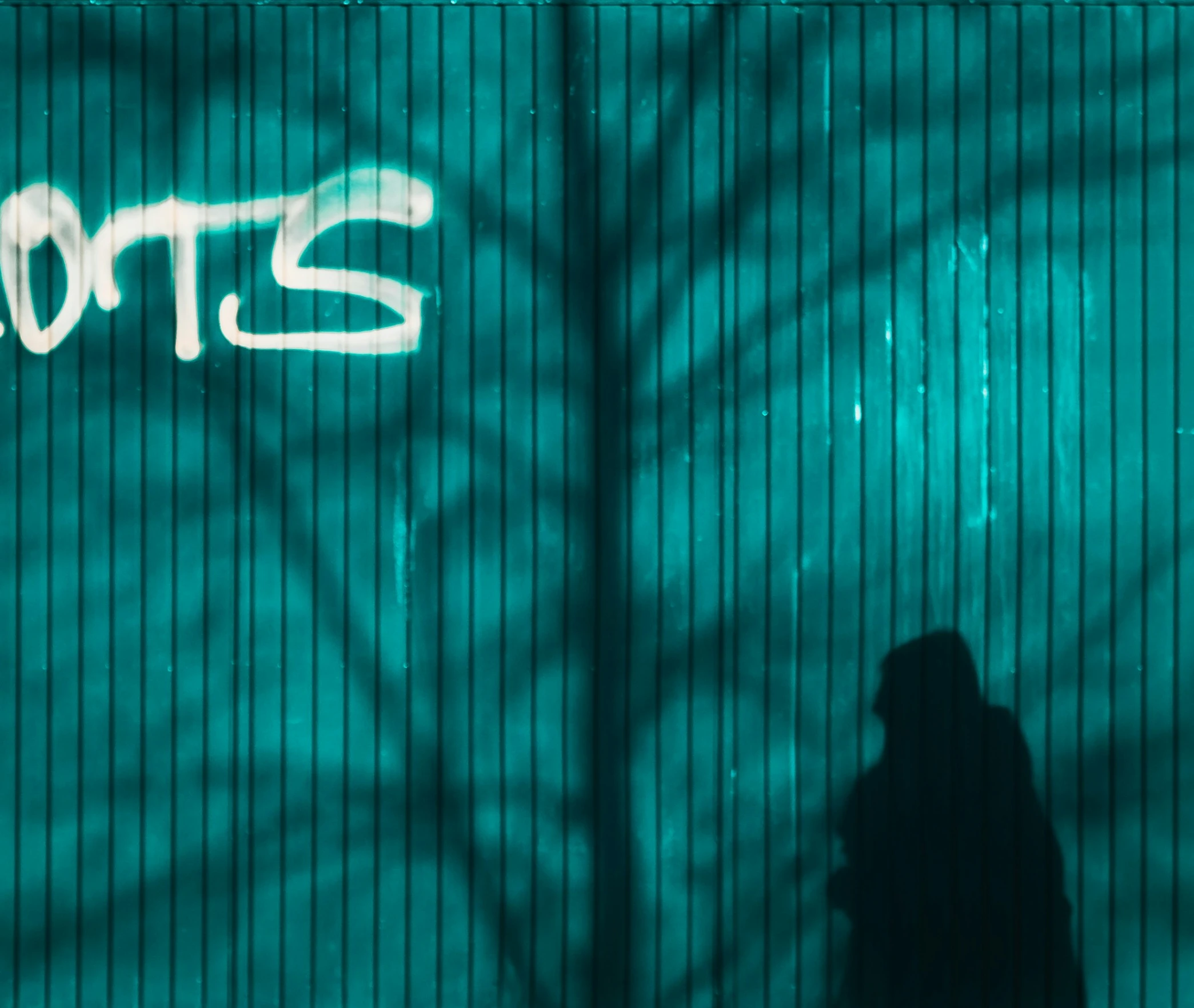 a man is walking past a graffiti that reads pants