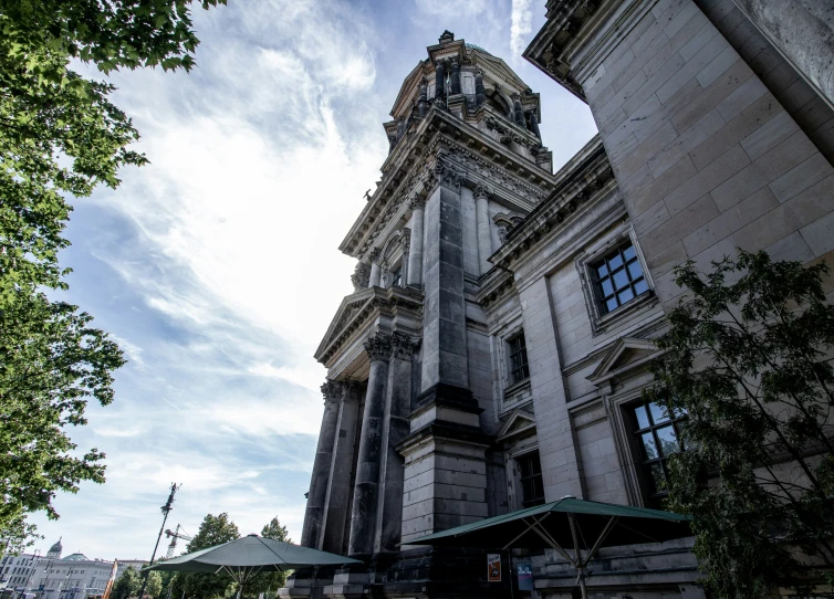 a tower structure with trees and buildings in the background