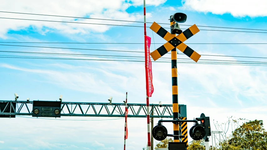 a railroad crossing with an electronic signal at an intersection