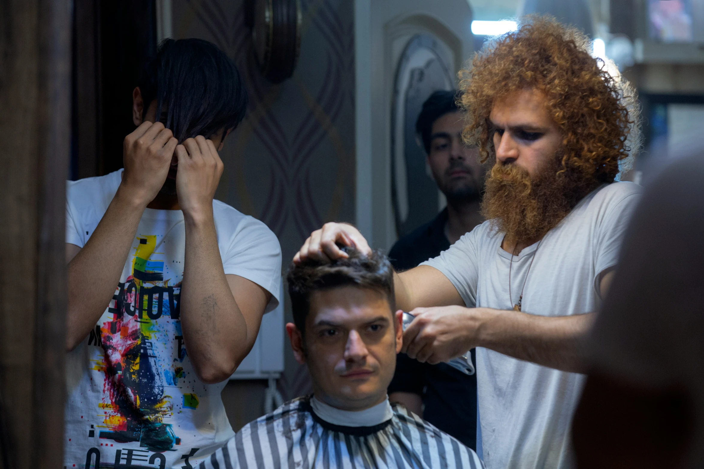 a person standing at a haircuting station getting their hair done