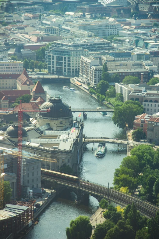 an aerial view of a large river with buildings and a bridge over it