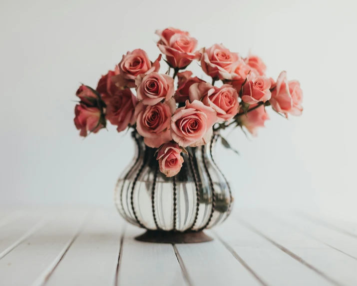 a vase with some pretty pink roses in it