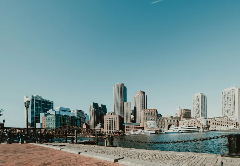 a large body of water next to a city with tall buildings