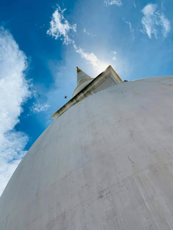 the top of a building under the clouds