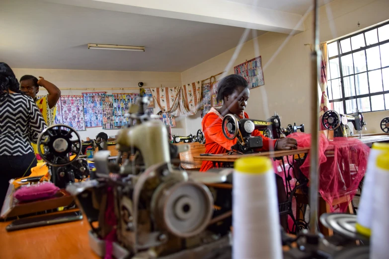 woman working on sewing machine at a table