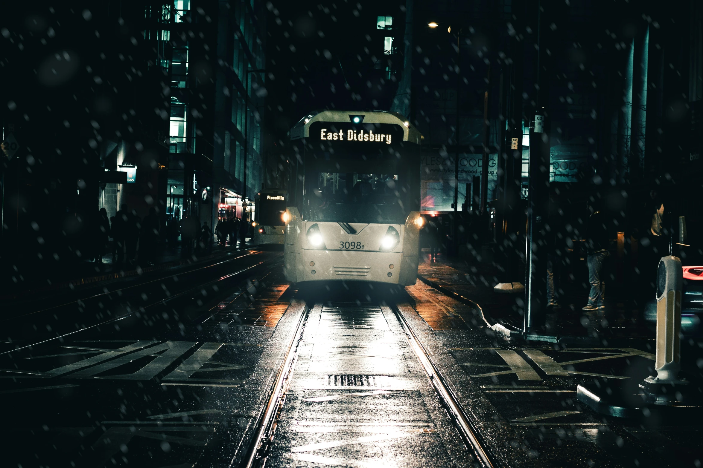 a commuter train speeds through the city at night