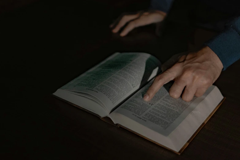 a man is touching a book with his hand