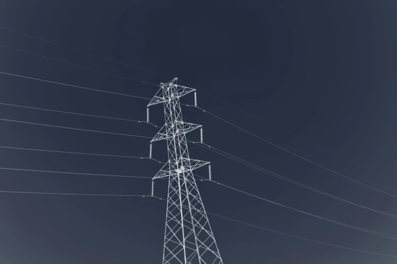 some electrical poles and wires against a dark blue sky