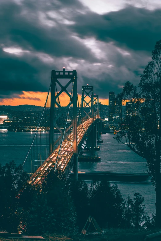 there are lots of lights on the bridge at night