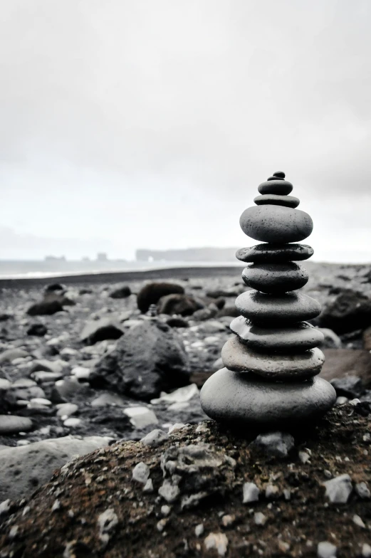 stacked rocks sitting on a rocky beach