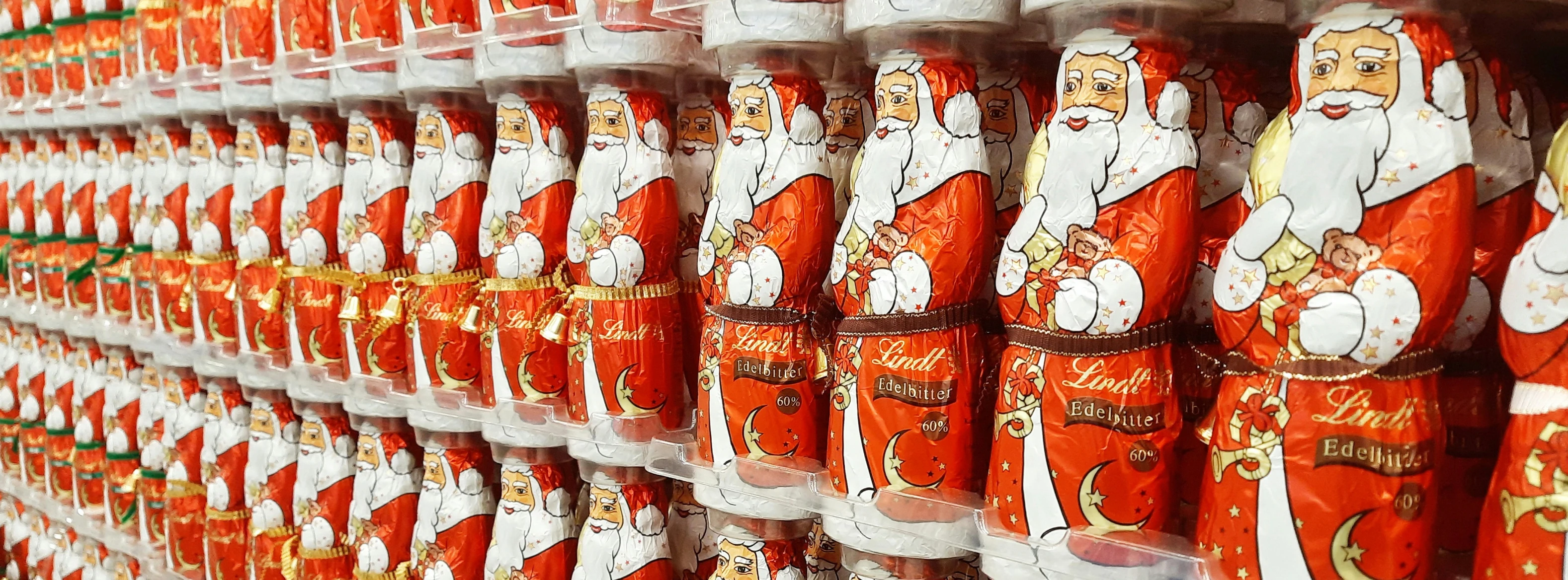 christmas decorations are stacked up on display in the store