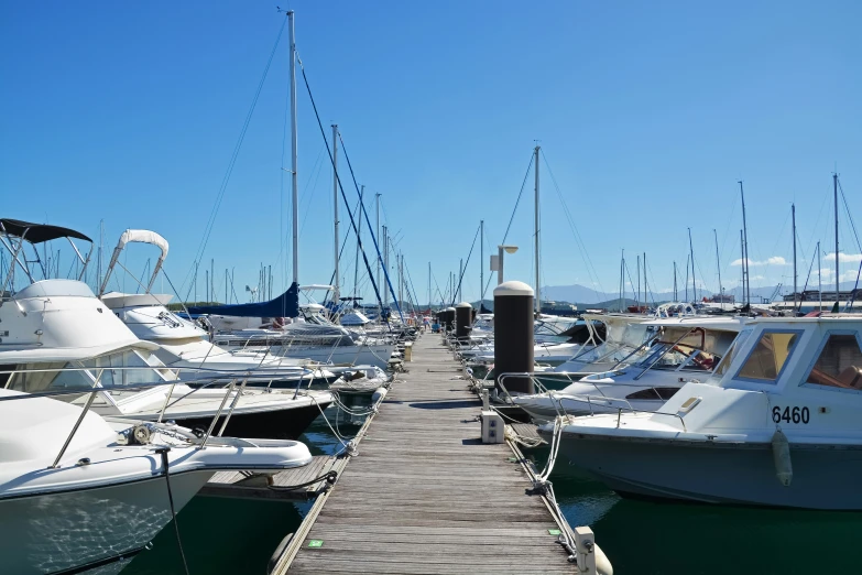 several boats sitting docked and parked at the pier