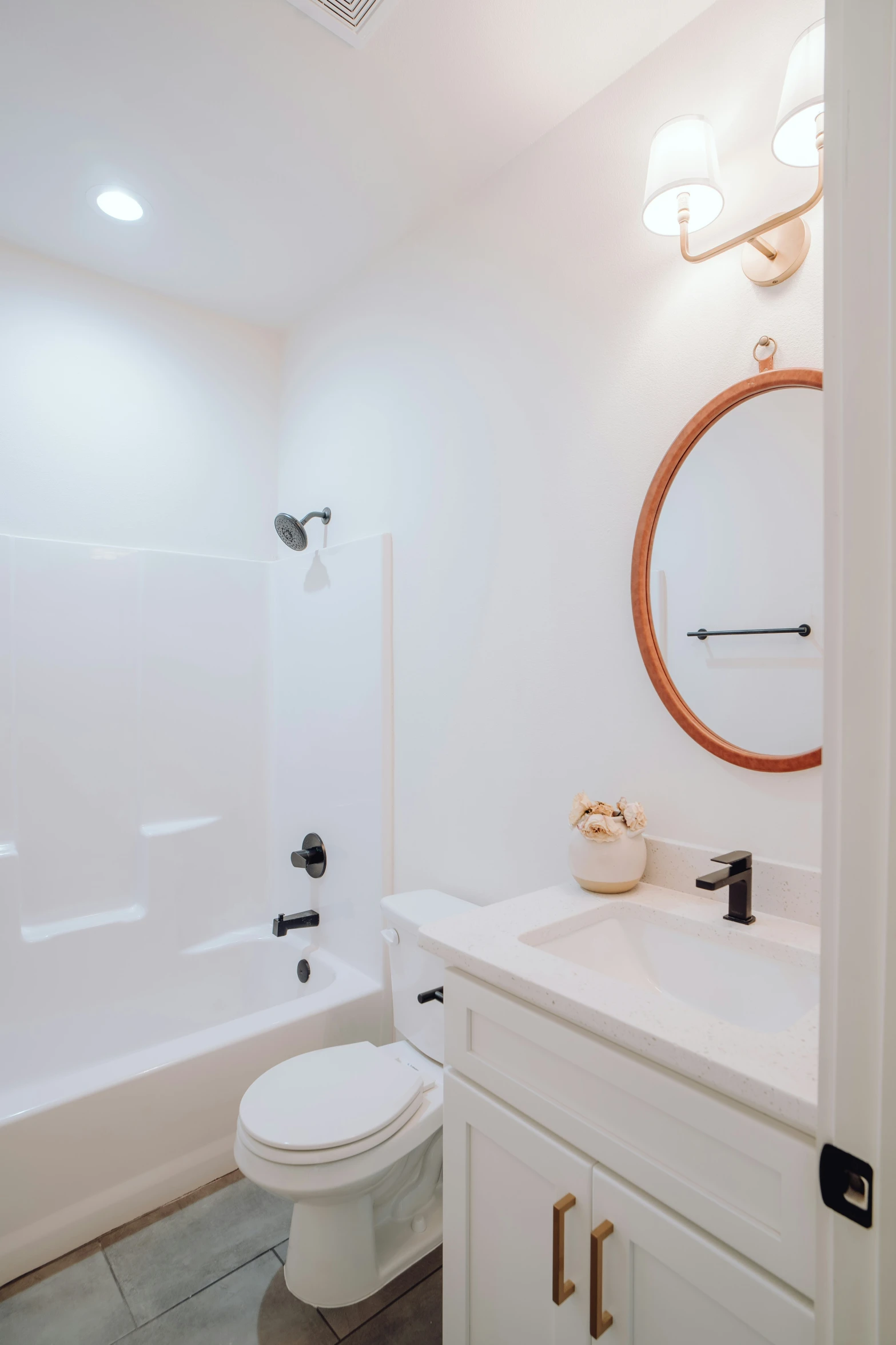 a white bathroom with a toilet, sink and bathtub