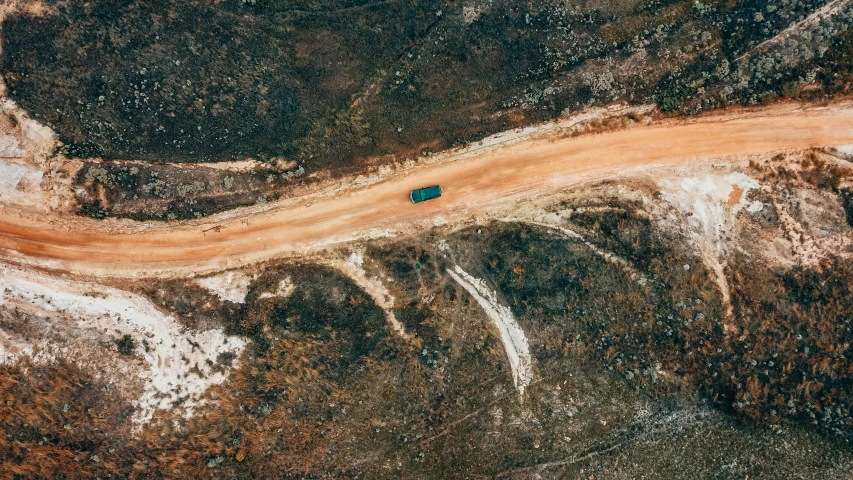 a truck driving down a dirt road