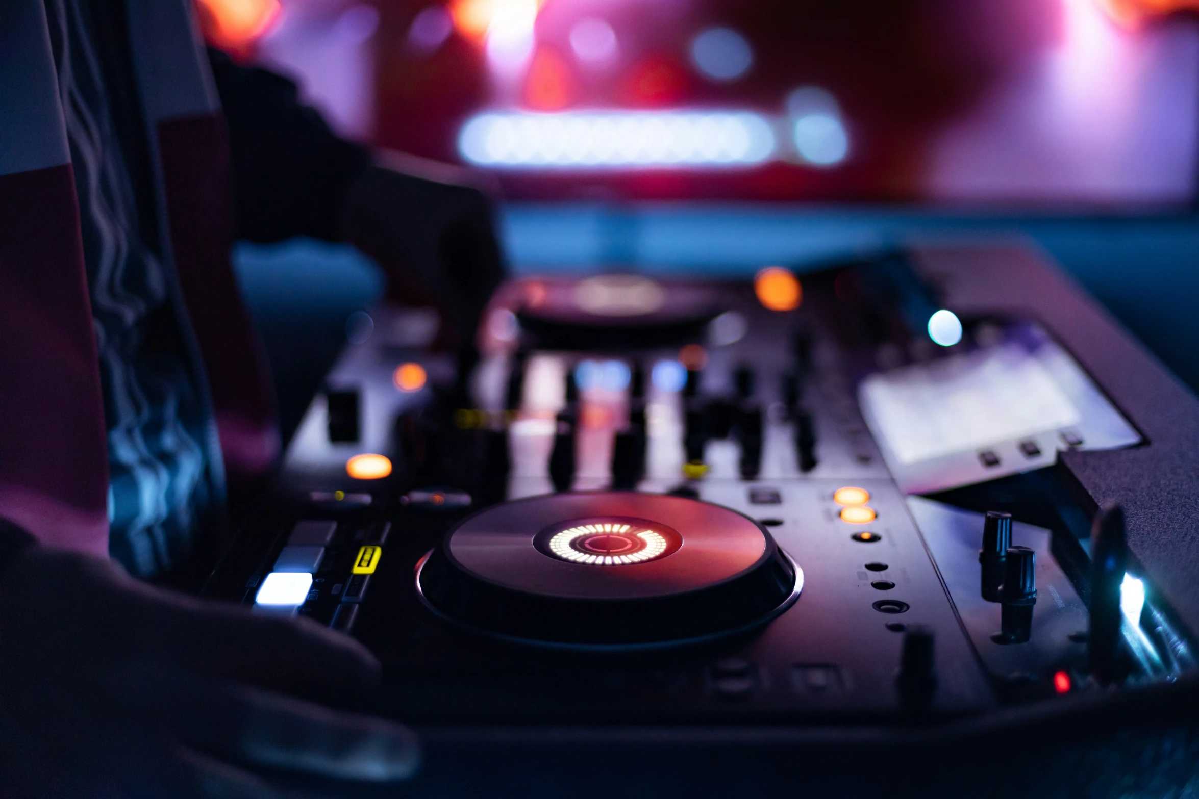 dj mixing in front of a large screen monitor