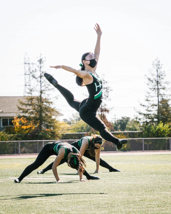 there is a man that is performing a stunt on the field