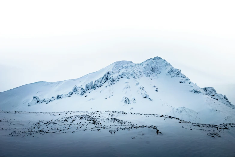 the mountain is covered with snow and mist