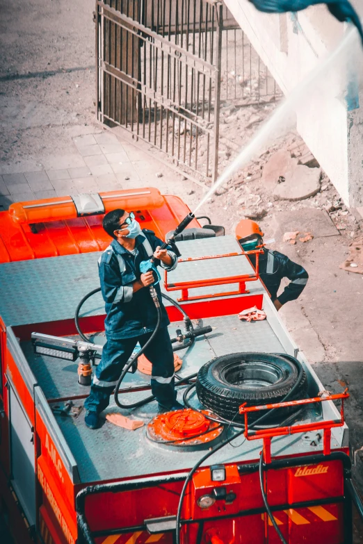 a man is spraying fire extinguishers with a hose on a truck