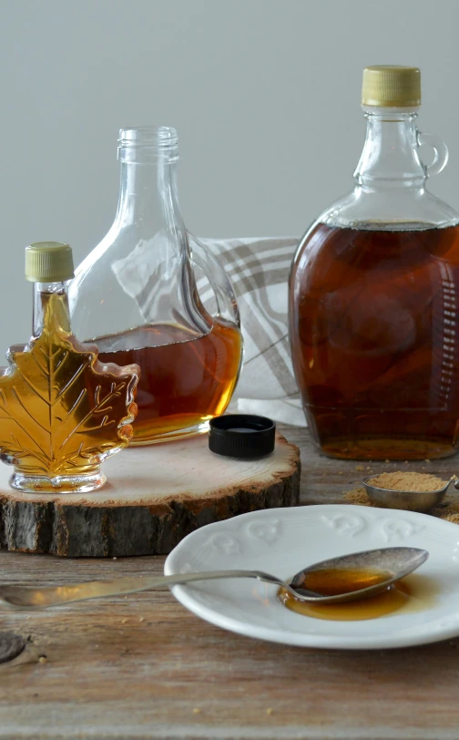 maple syrup sits on a plate and beside the maple syrup bottle