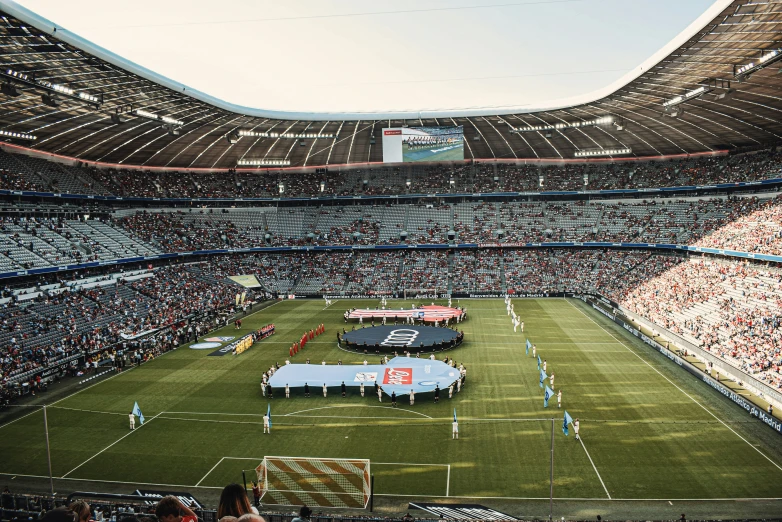 a very big soccer stadium with lots of people watching it