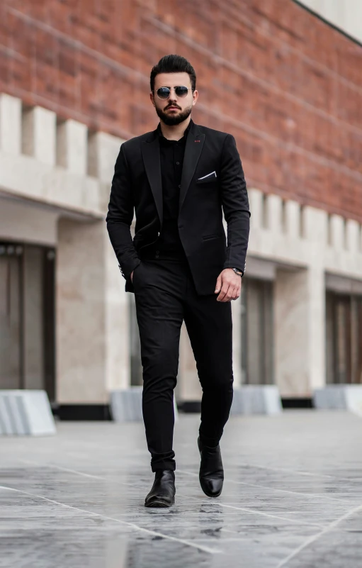 a man is dressed in all black and carrying his purse