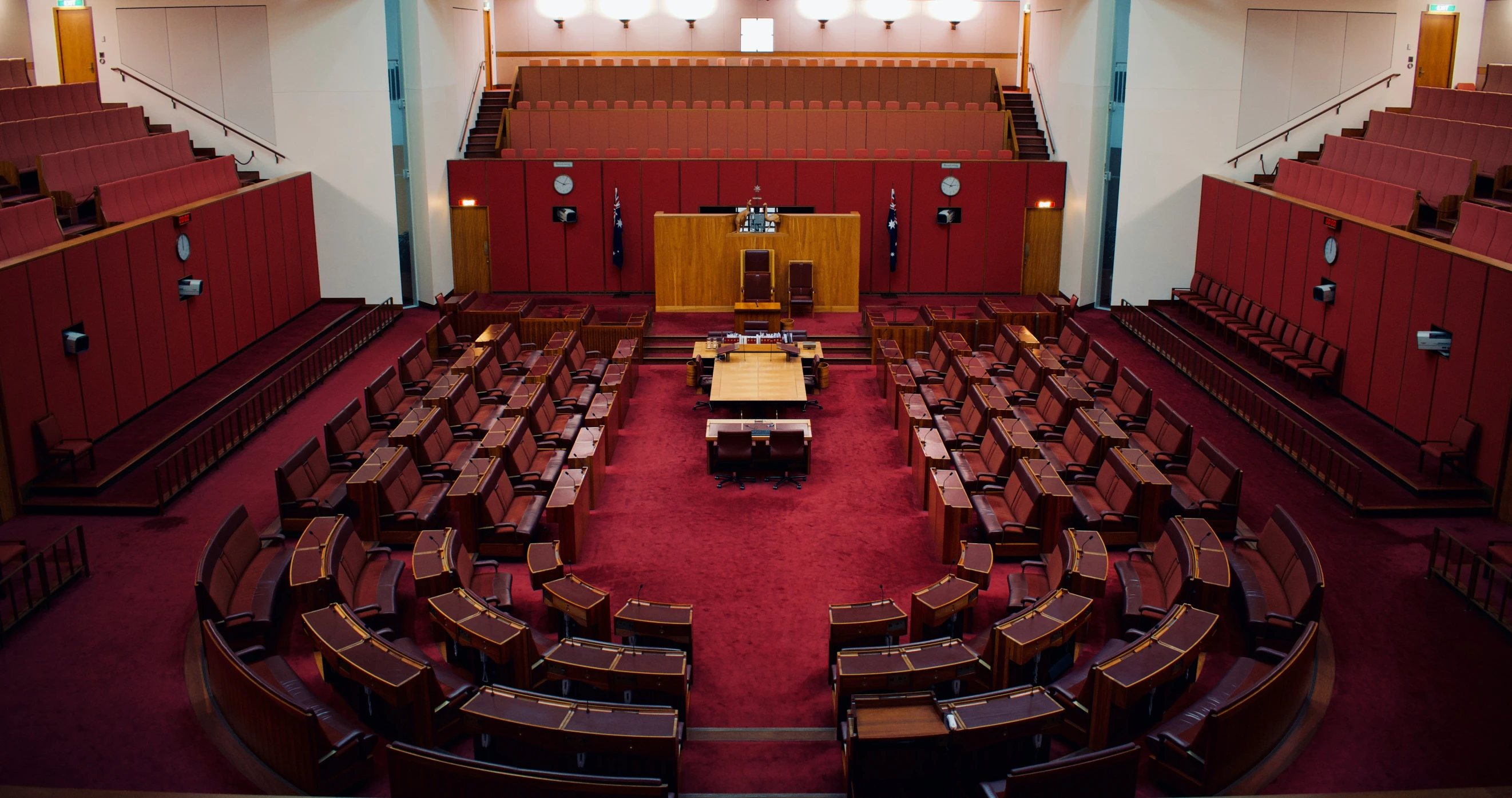 an empty auditorium with wooden seats and lights