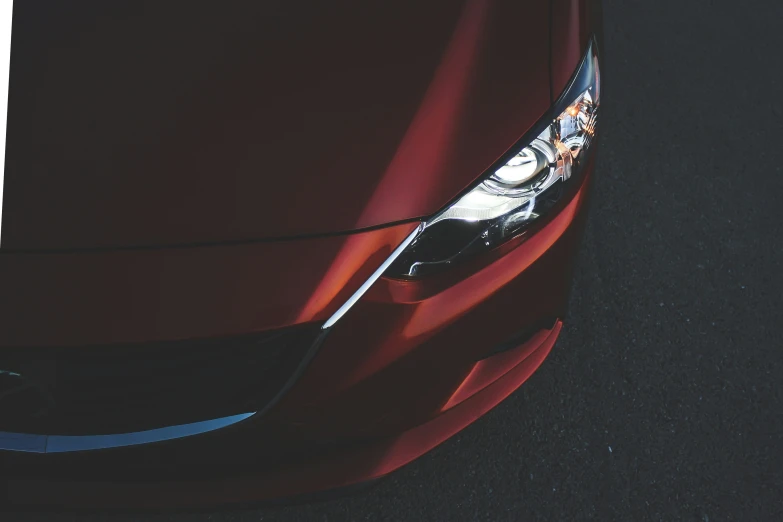 an aerial po shows the front end of a red car