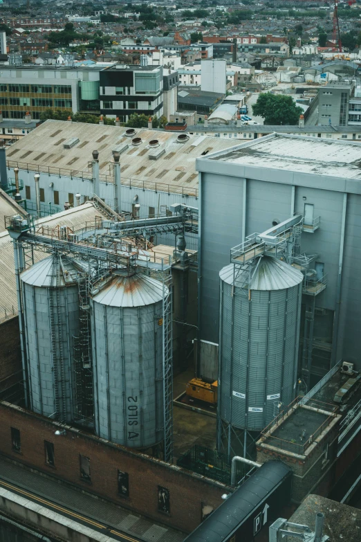 a factory filled with water tanks and industrial buildings