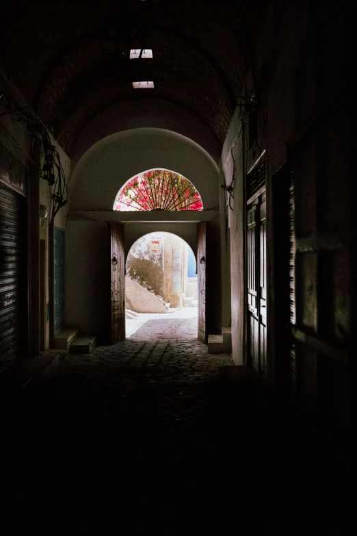 a po taken from underneath an archway between two buildings