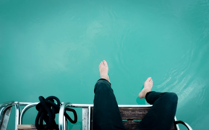 someone's legs and feet are up in the air above a chair