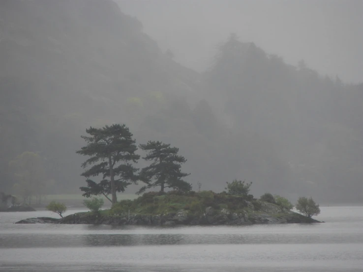 a body of water with a lone island in the middle