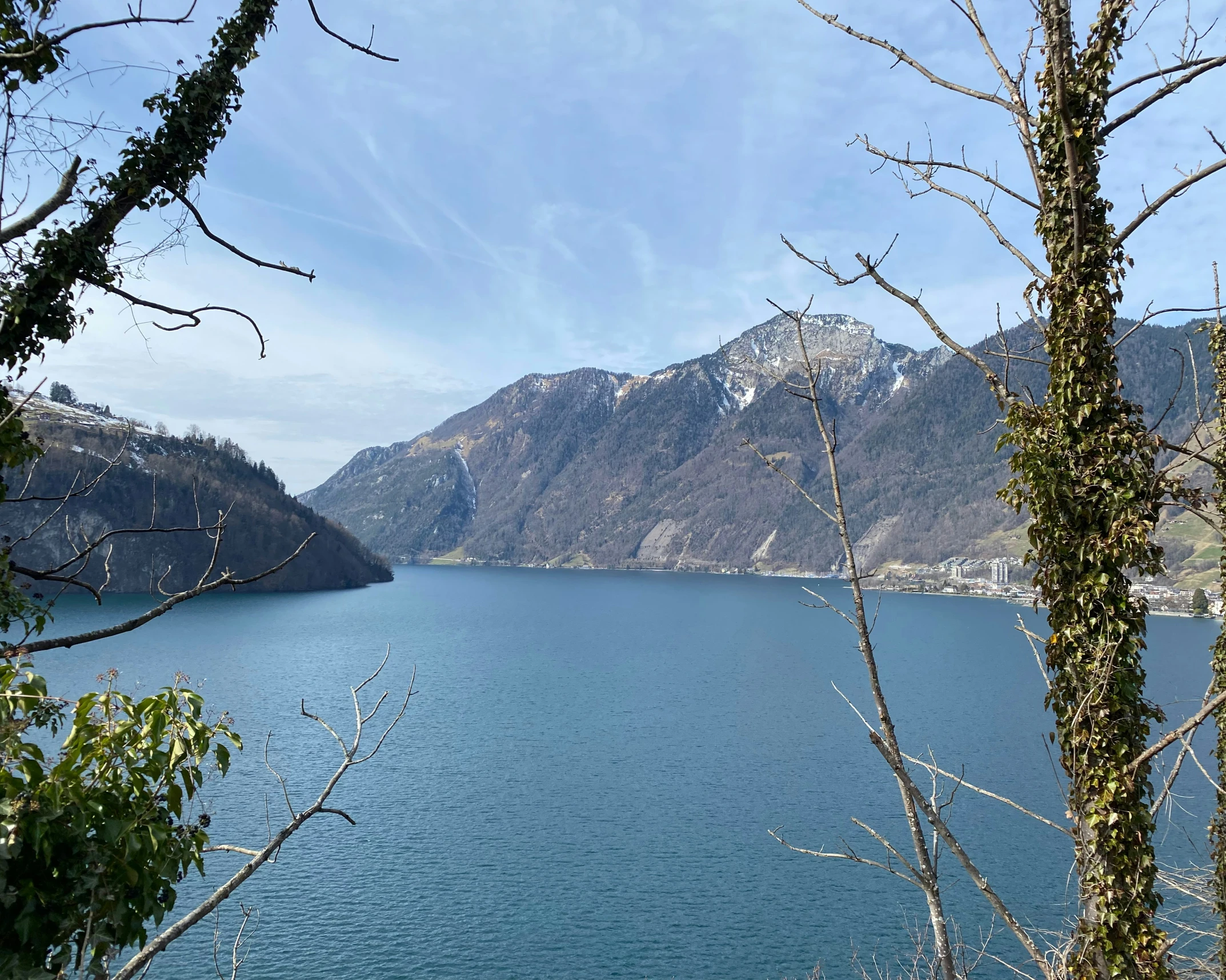 some snow covered mountains and the blue water