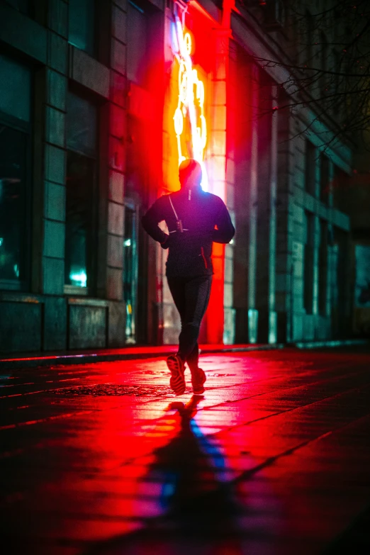 a person in black jacket walking on the street