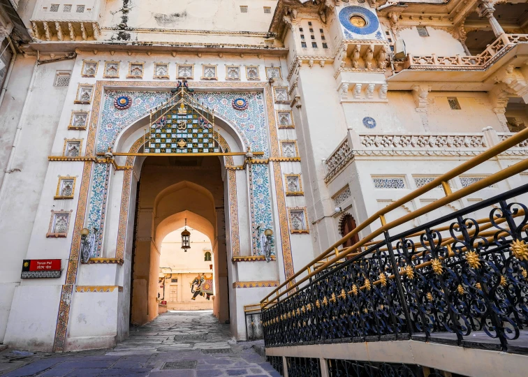 a gate with tiled work is in front of a building