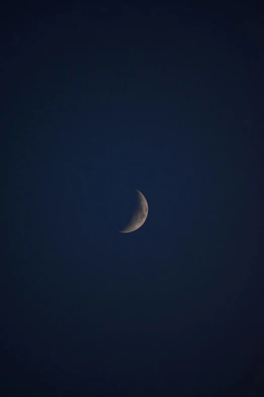 the moon can be seen through some clouds during this time of night