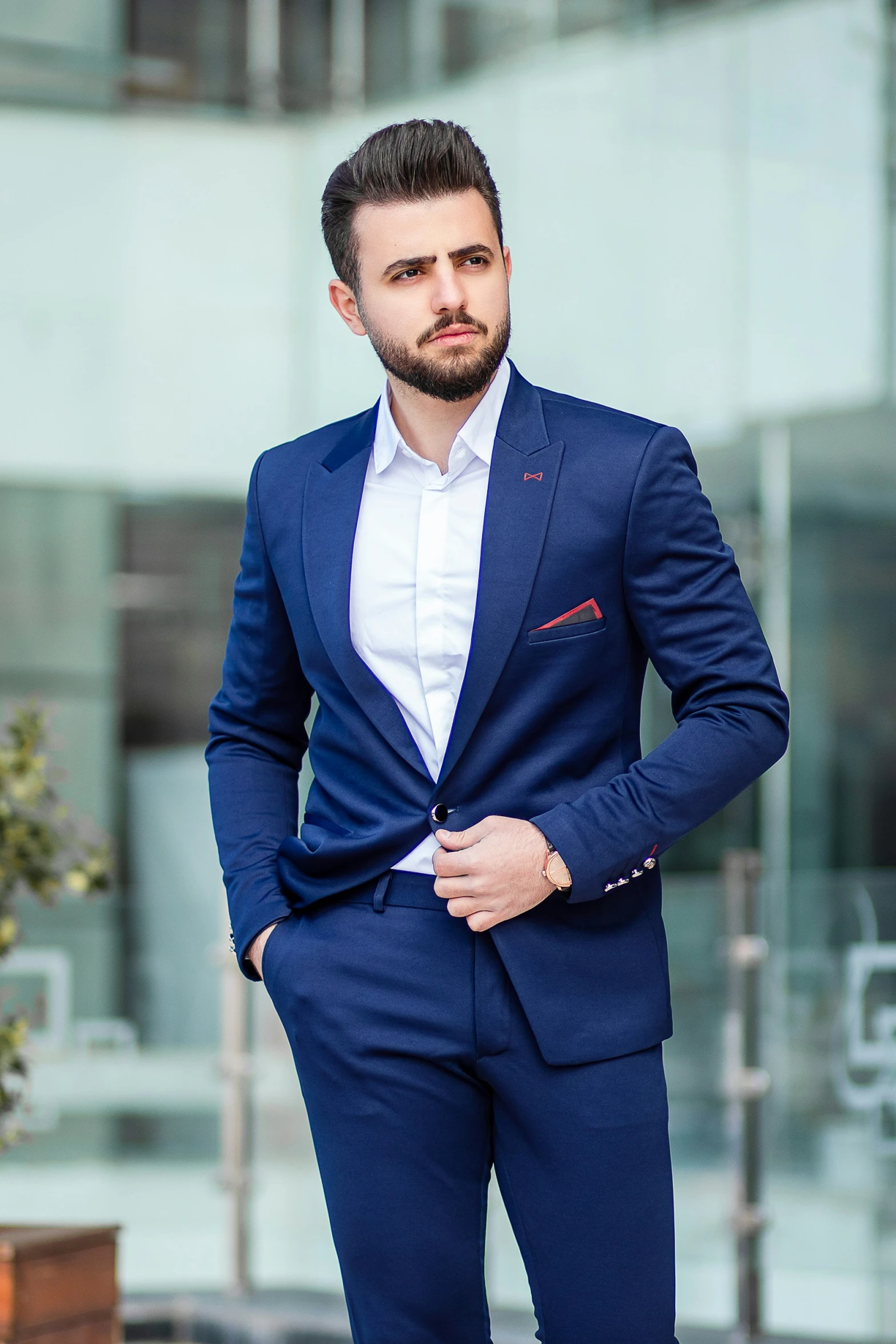 a man is standing outside in a blue suit