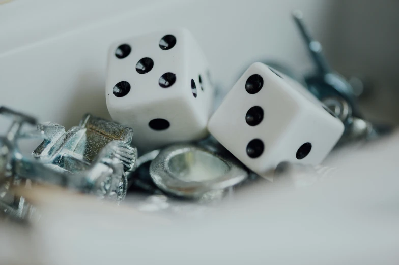 three dice that are being held together with pliers