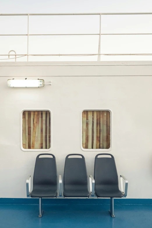 two chairs are placed on the side of a cruise ship