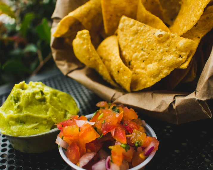 some nachos and salsa are on a tray