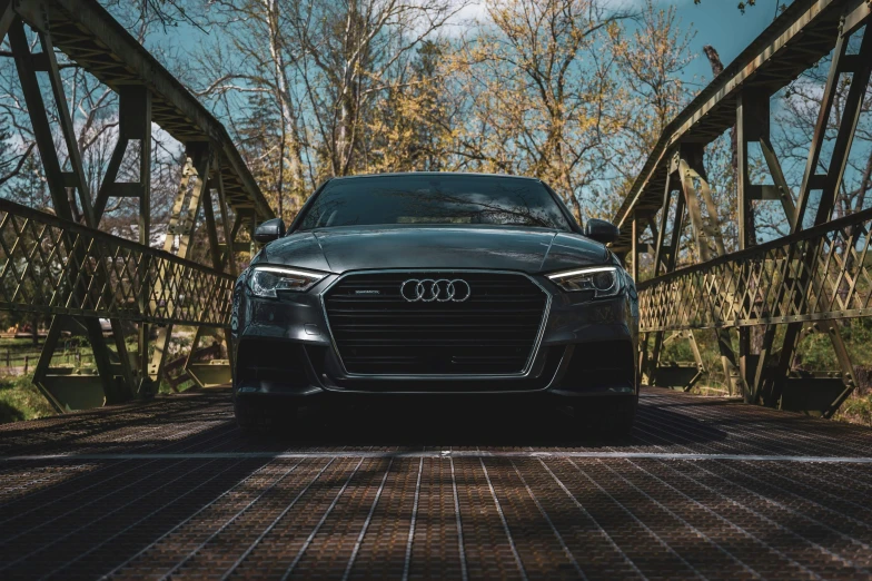 the front of a parked car in a wooded area