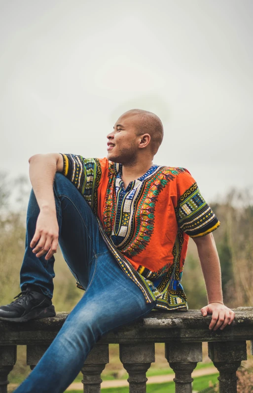 a man leaning on a wooden fence with his legs up