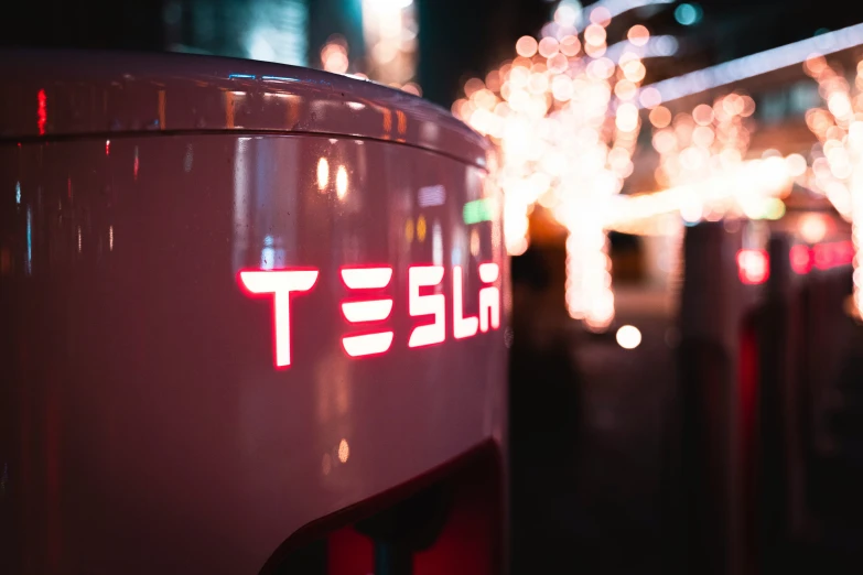 a tesla car on the side of a road