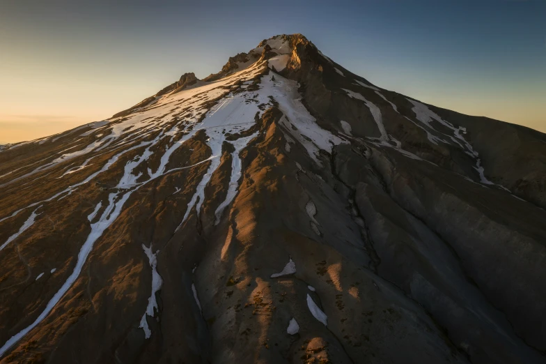 a mountain side covered in snow next to a sky